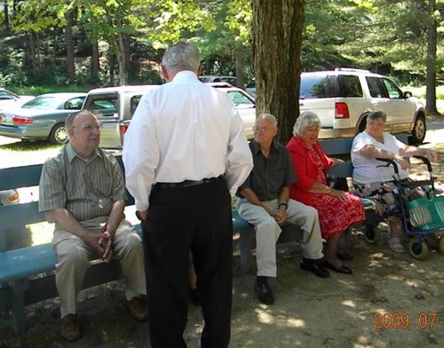 Dr. Neihof waits outside the old dining hall with friends