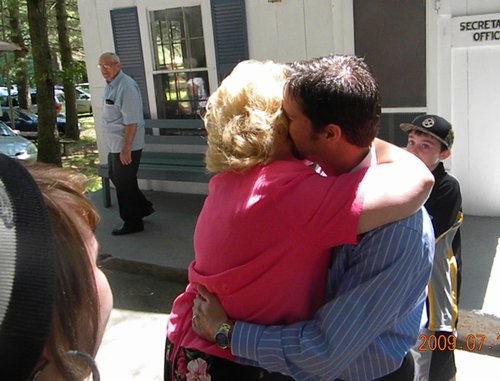 Mother and son share a hug